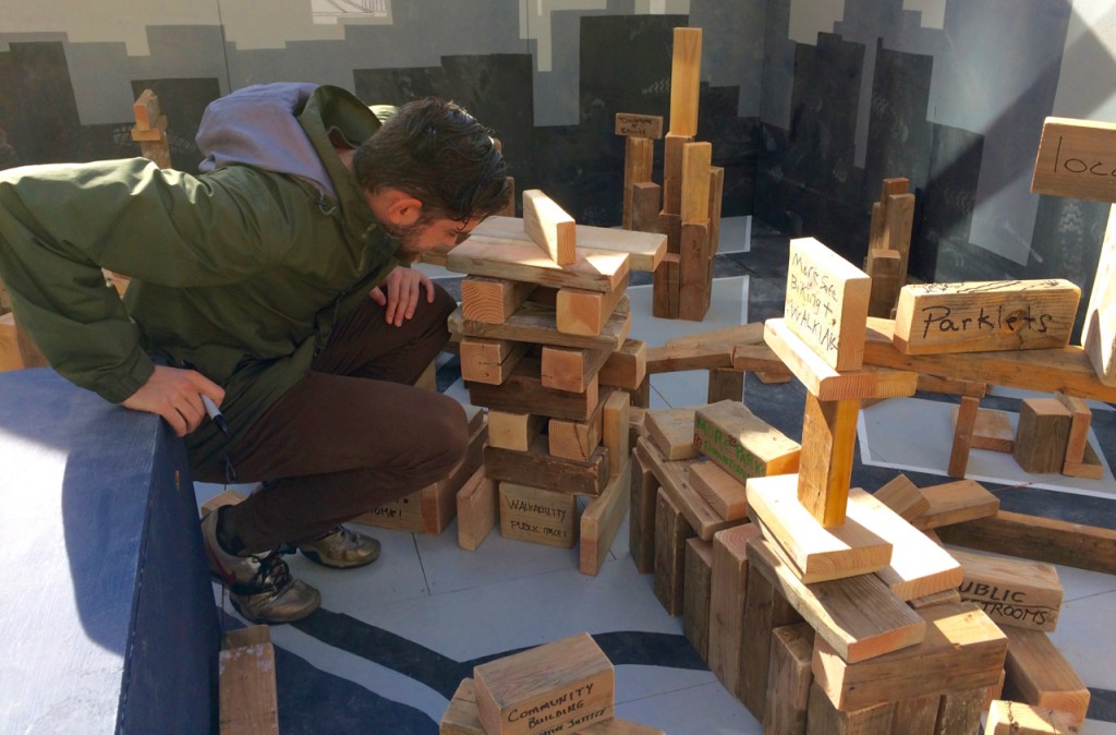 Visitors got to write their vision for the future on scrap wood and then stack them into a cityscape. Waaaay cooler than writing on a poster.