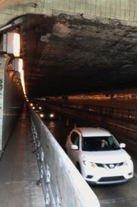 Cars emerge from the Oakland side of the Posey Tube