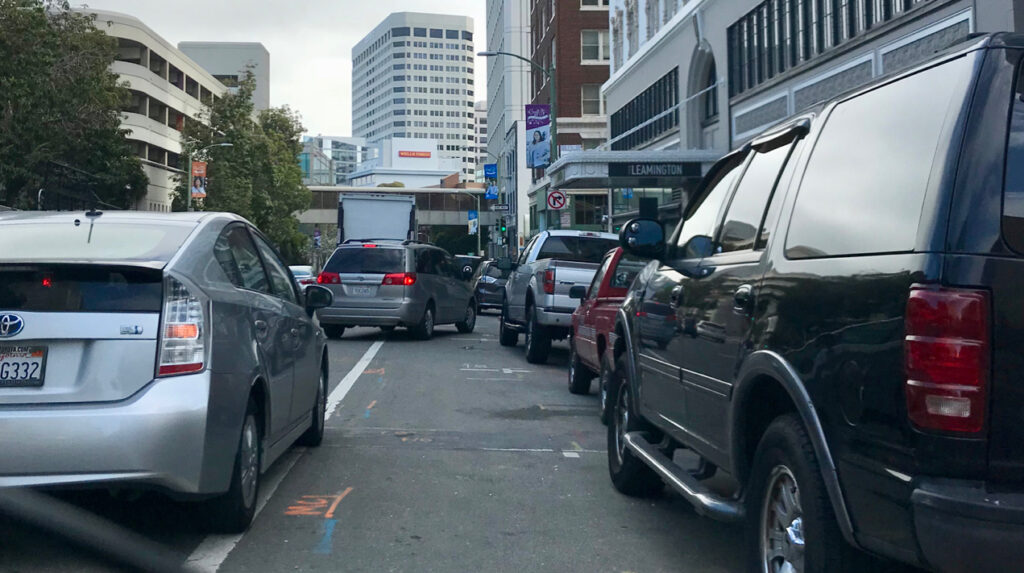 Cars block a bike lane on Franklin Street in Uptown Oakland